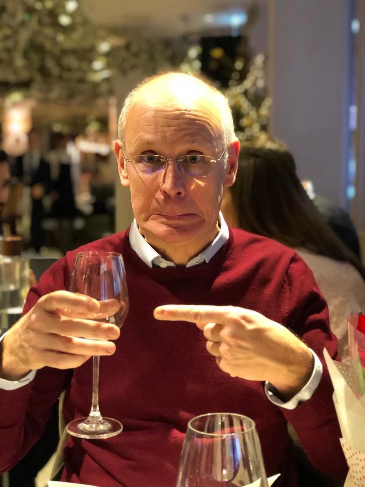 Nick holding a glass of wine